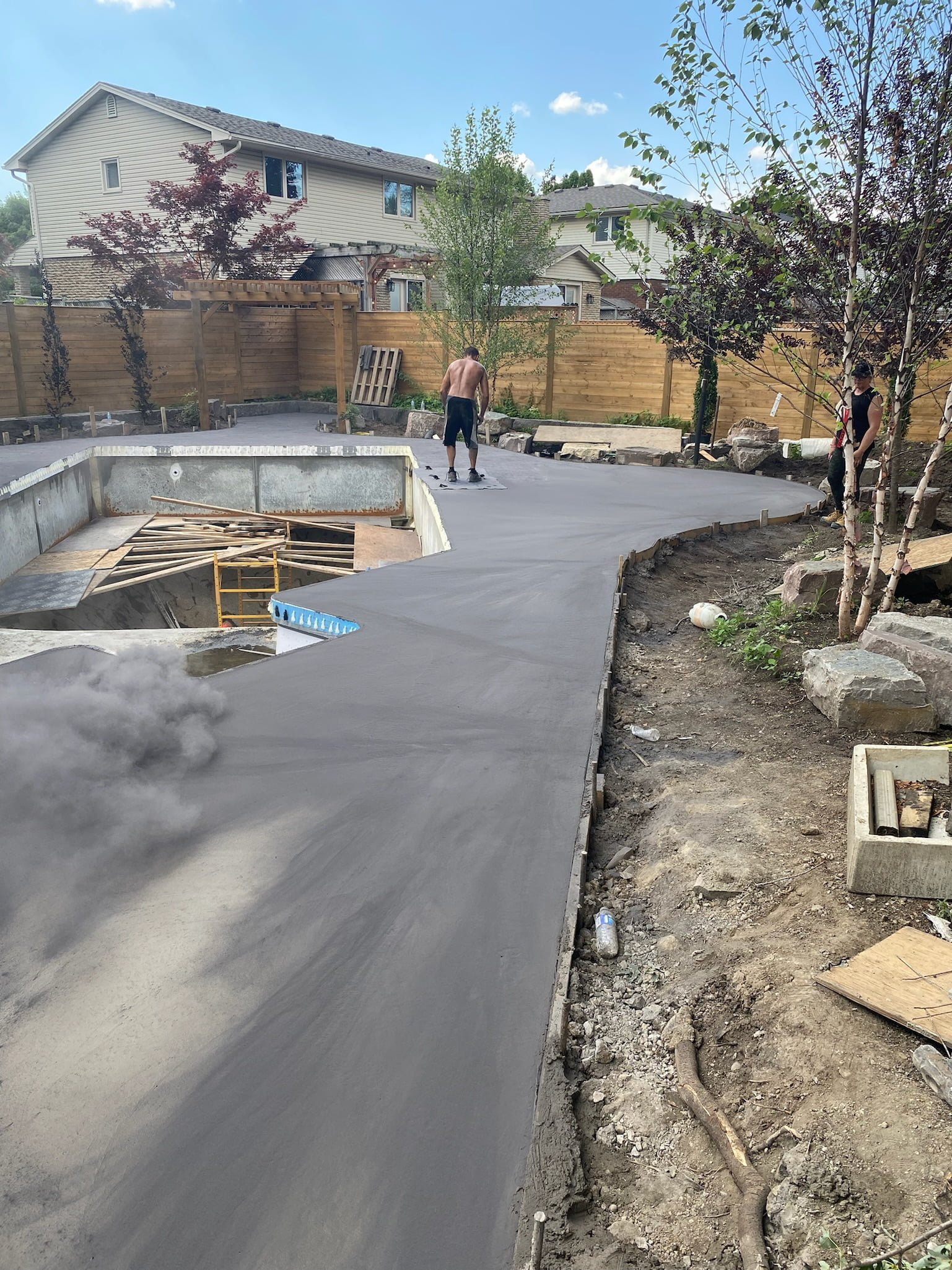 stamping pattern into new concrete pool deck