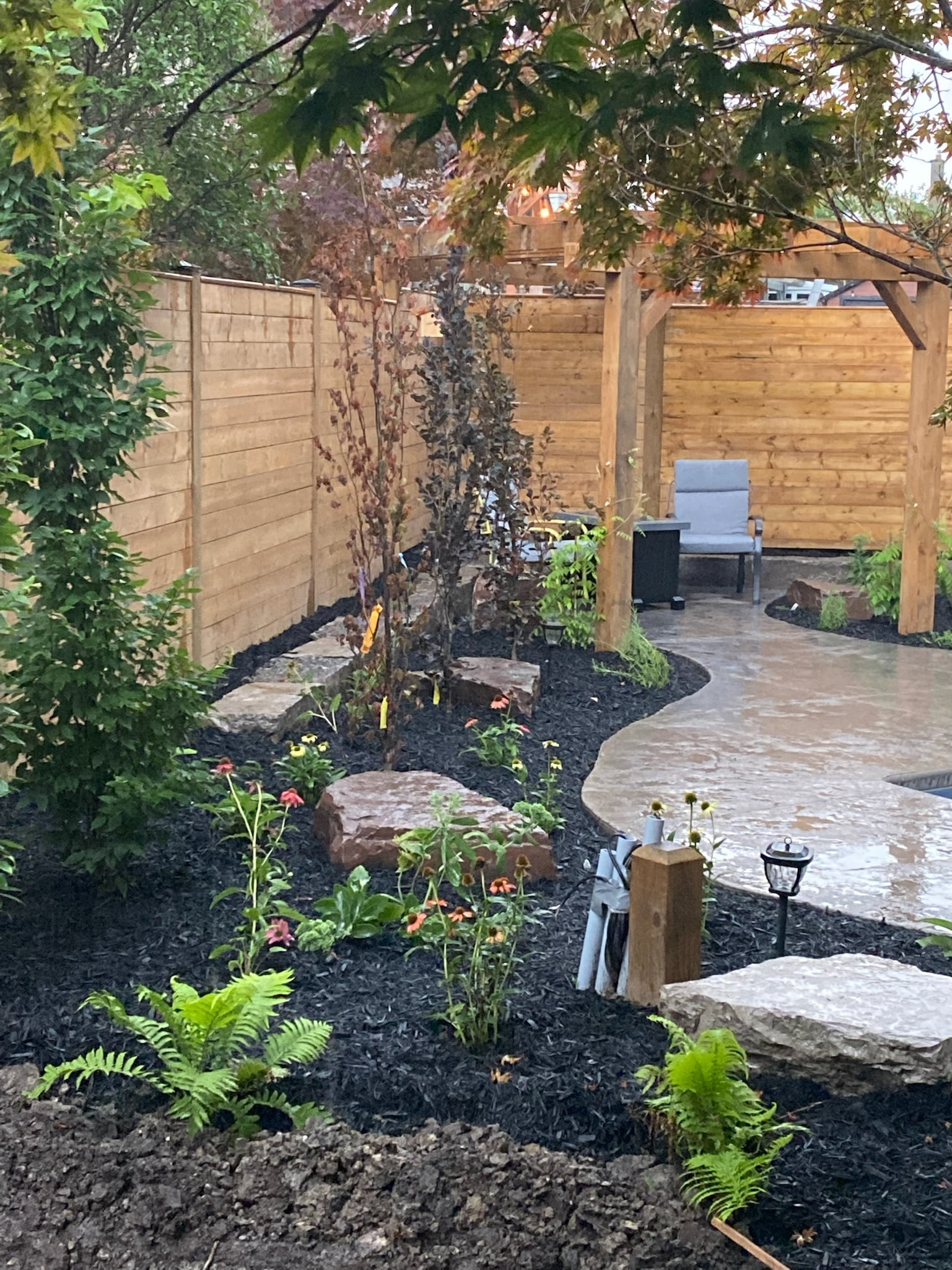 new concrete walkways and gardens in backyard