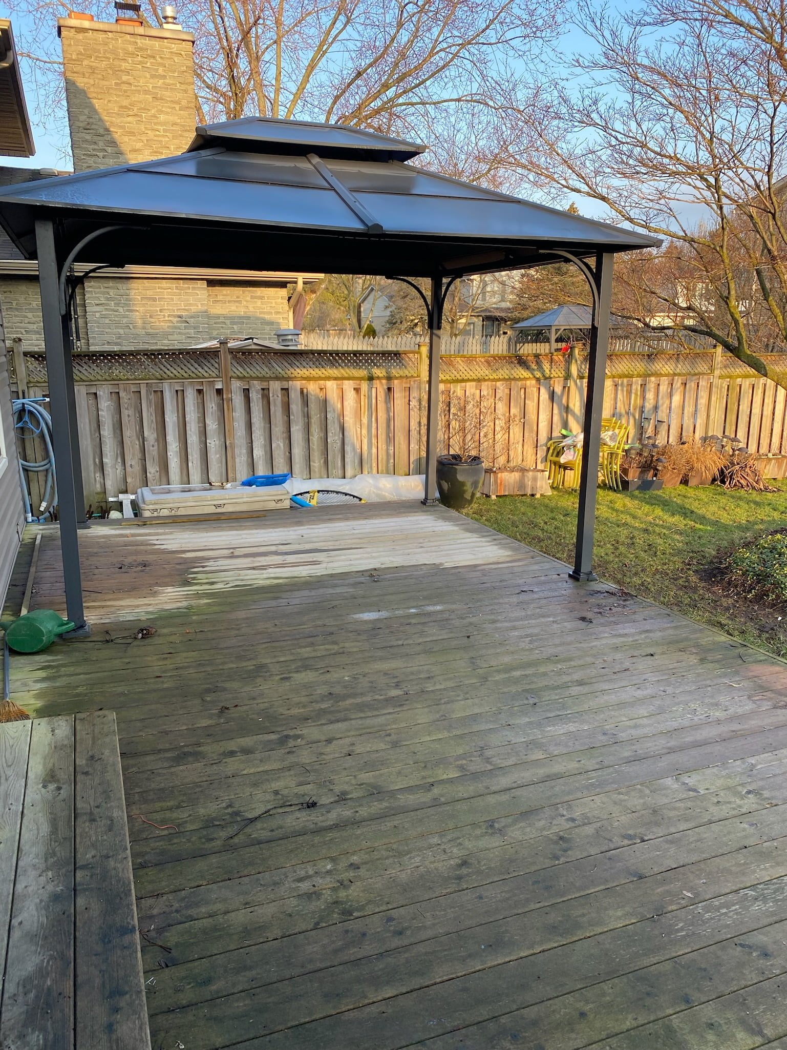 old wooden deck and metal shade structure
