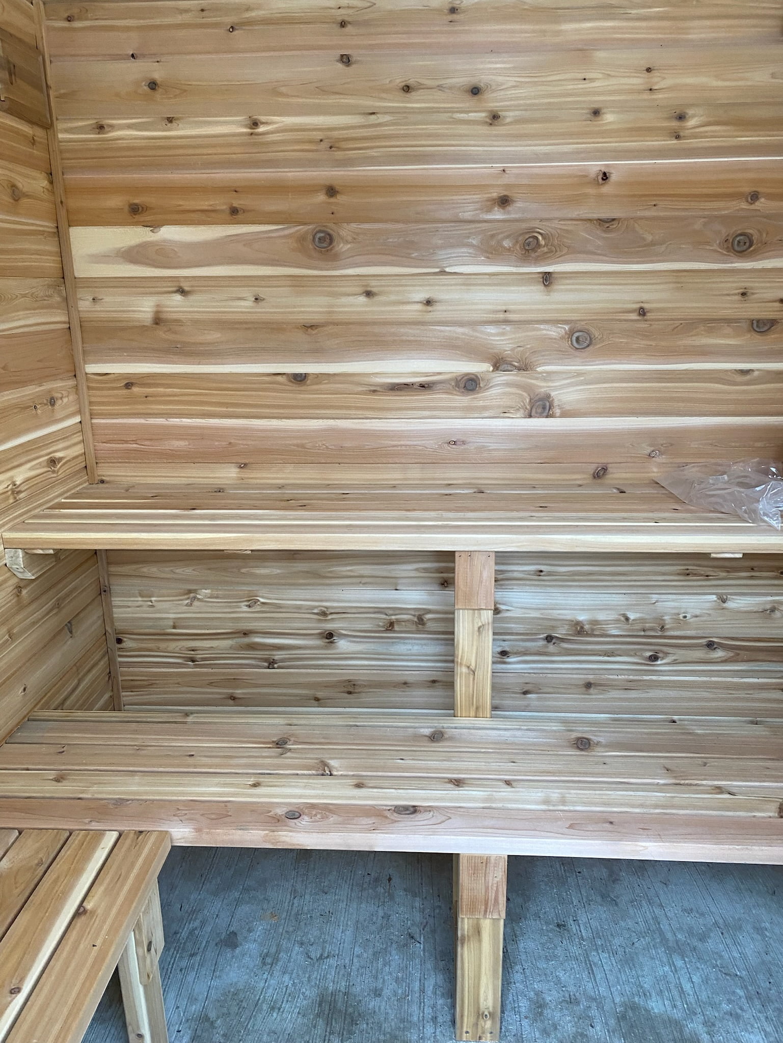inside view of custom pool shed with wooden walls and shelves
