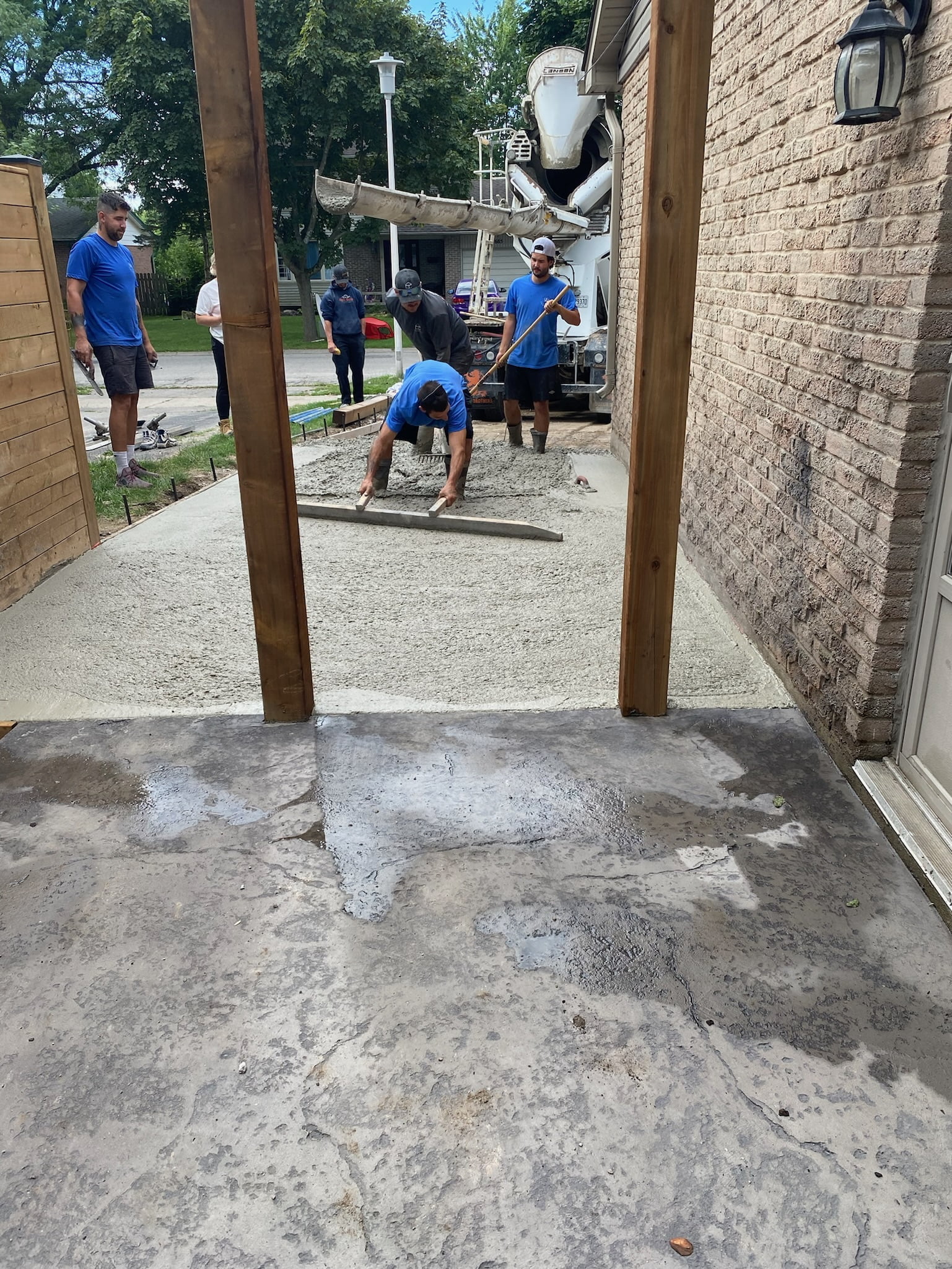 New concrete driveway in progress levelling wet concrete