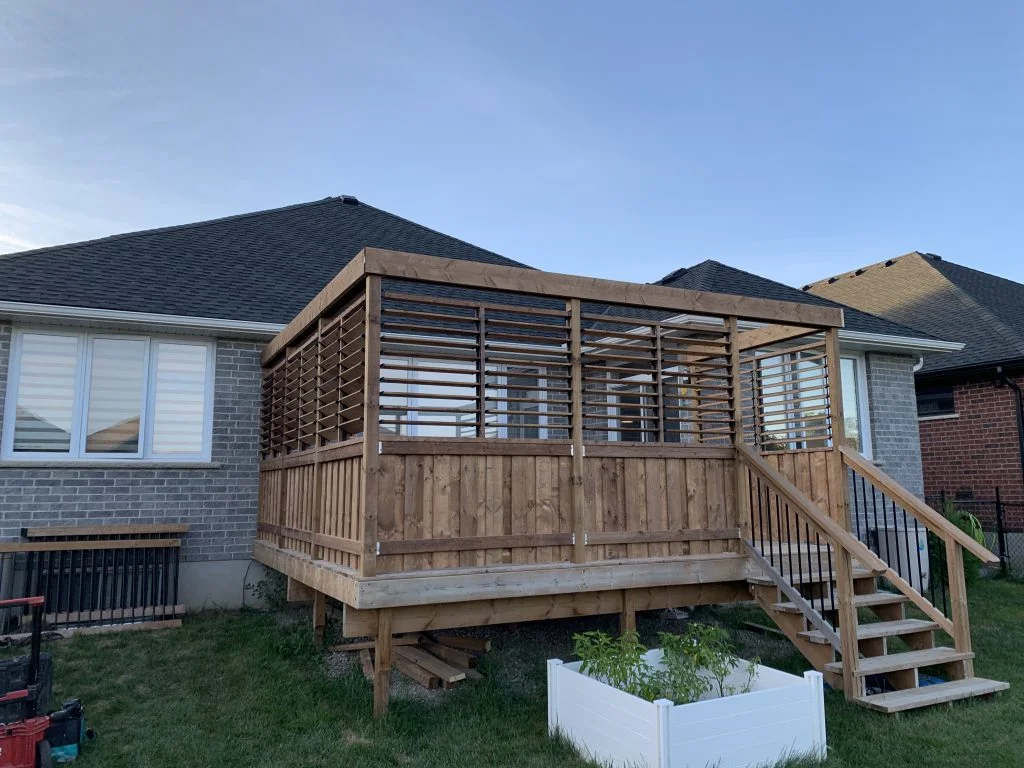 small wooden deck with privacy shutters