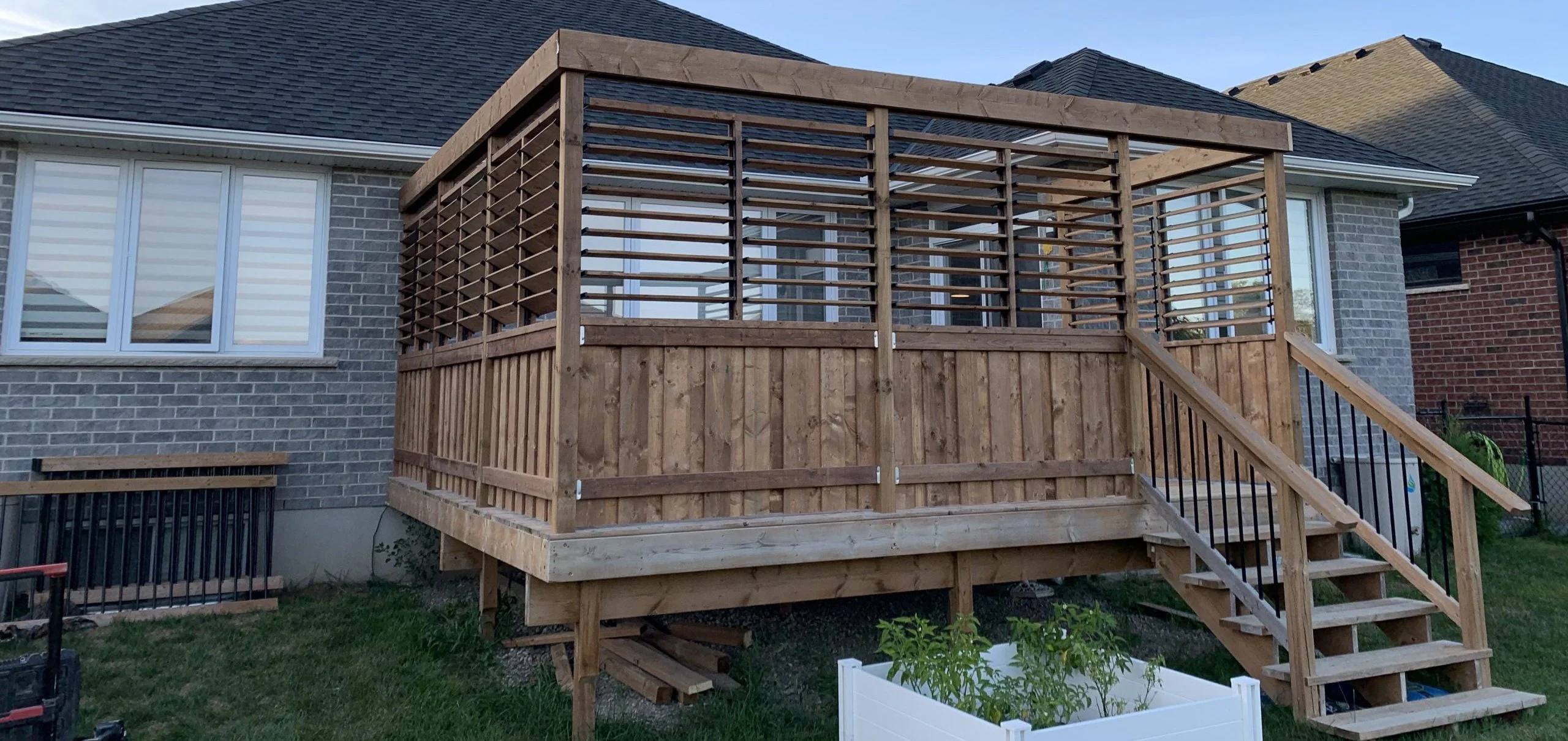 small wooden deck with privacy shutters