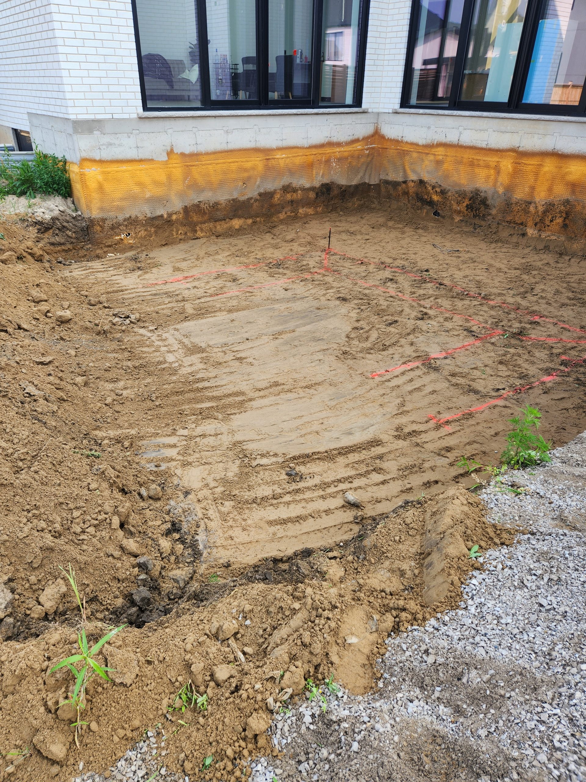 newly excavated backyard prepared for swimming pool installation