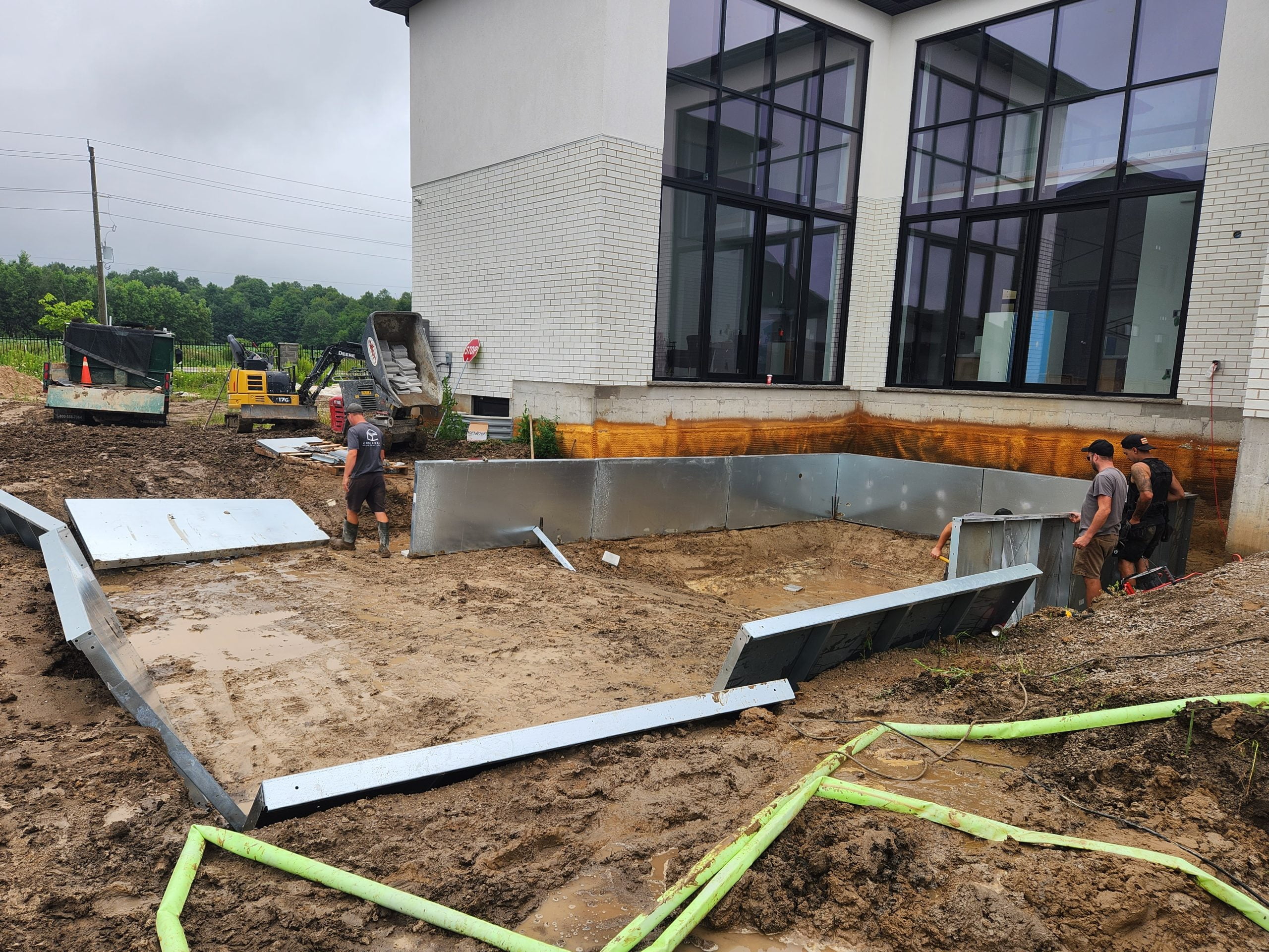 putting up wall panels for new custom inground pool