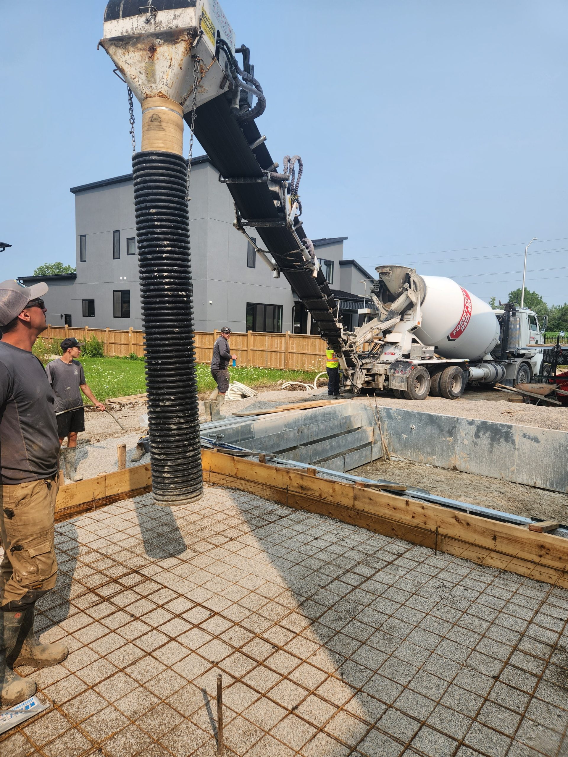 concrete delivery for pool deck surrounding inground pool