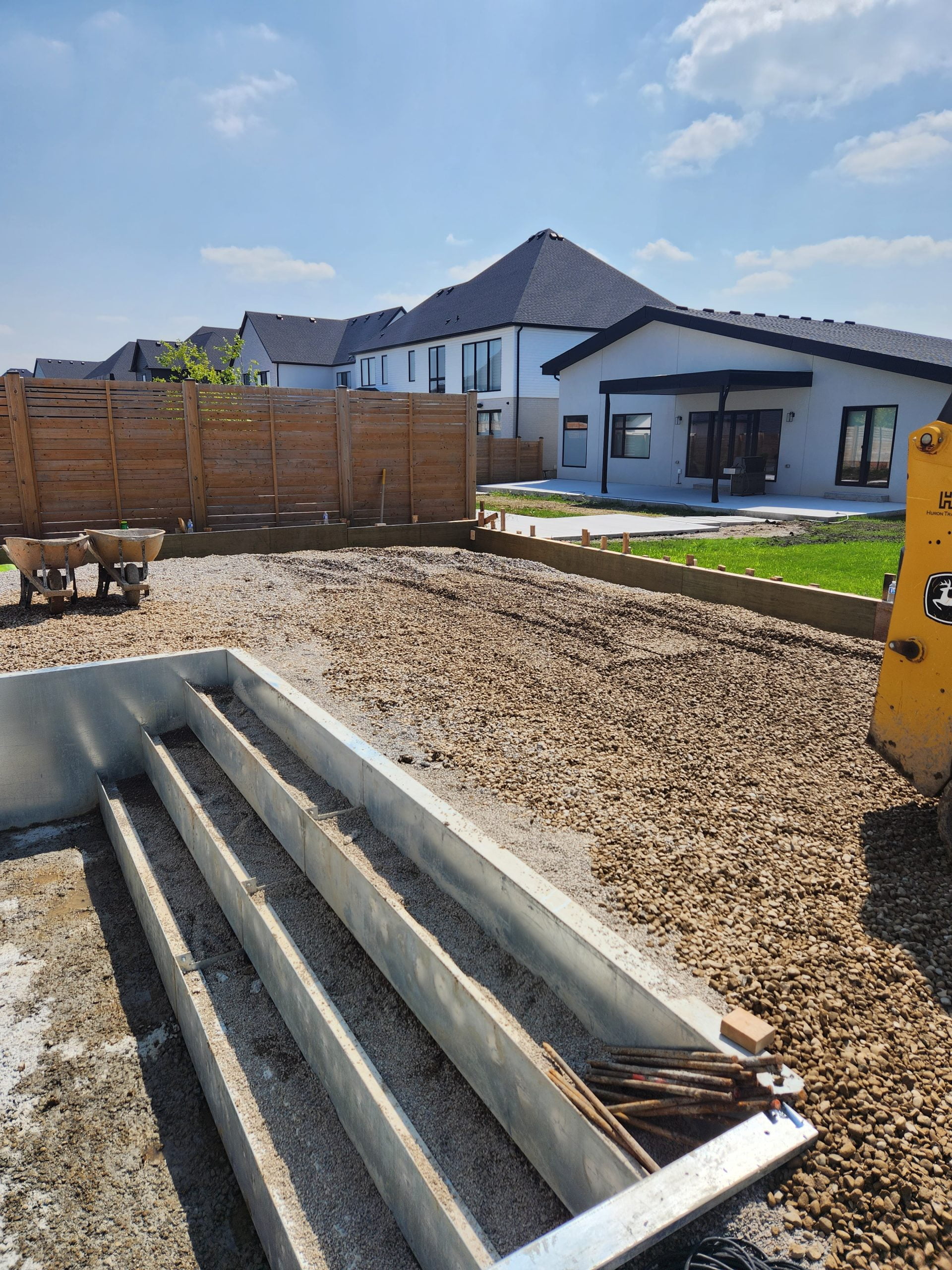 levelling crushed gravel for new concrete pool deck and patio