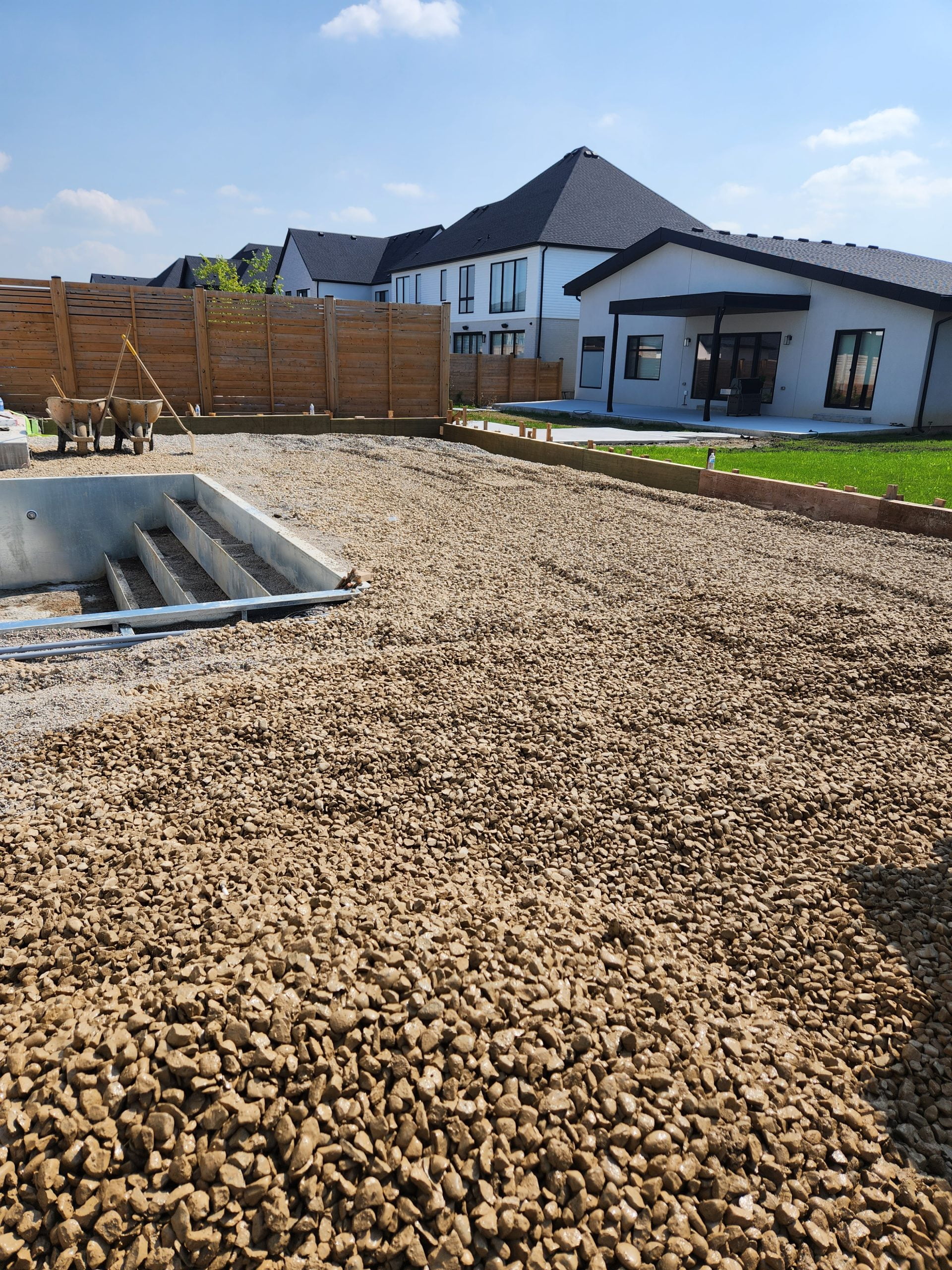 levelling crushed gravel for new concrete pool deck and patio