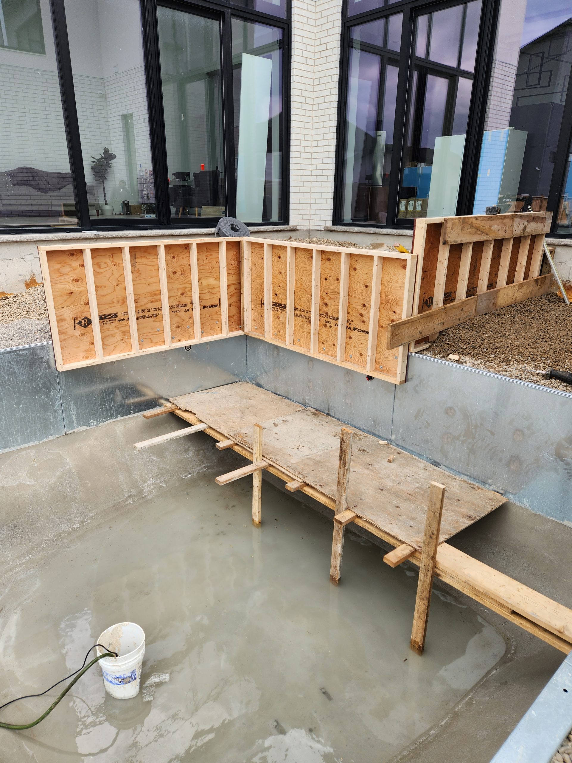 forming upper patio area at back entrance to the pool using 2 x 4 and plywood