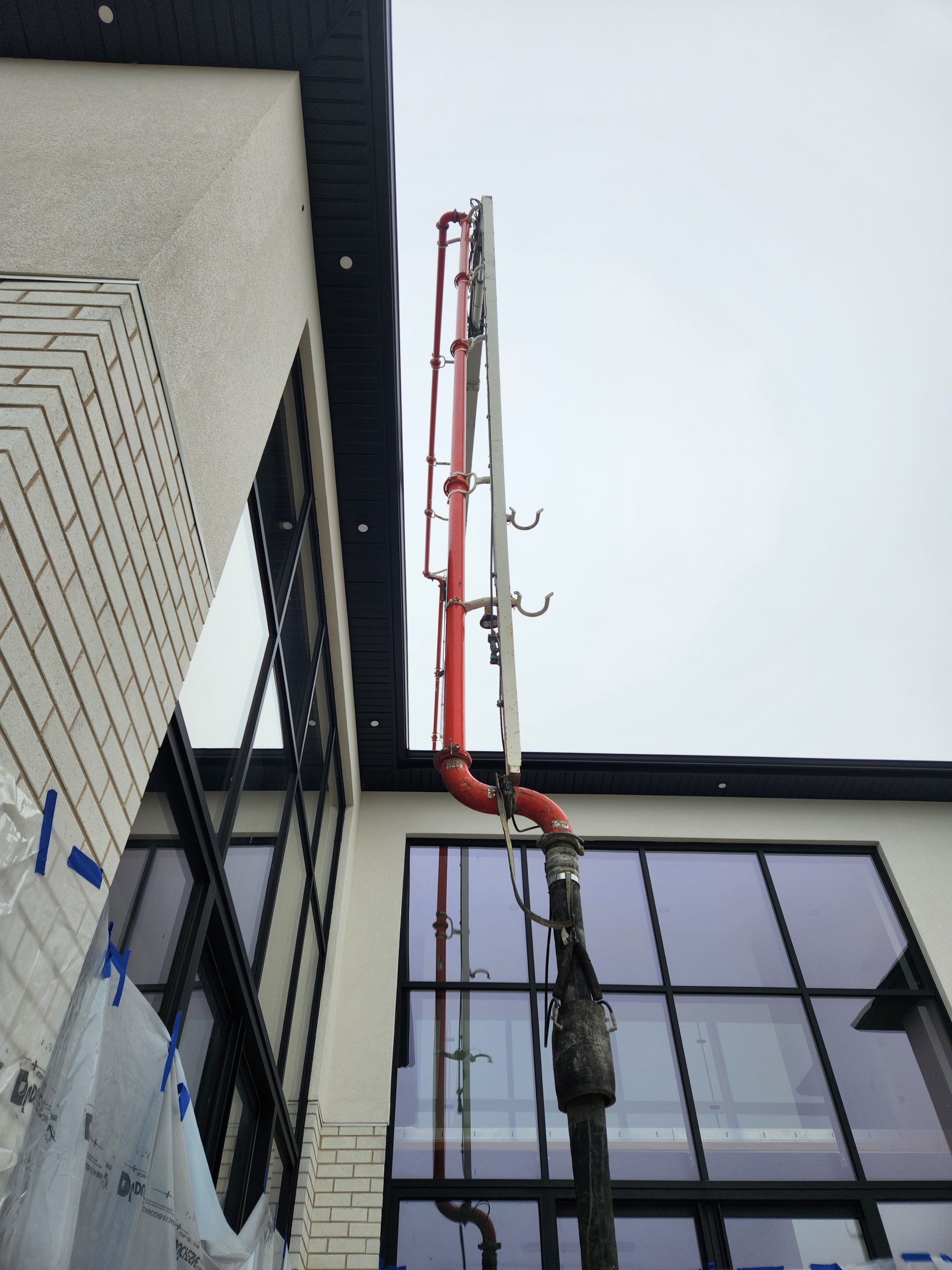 delivering concrete overtop of a house for new pool build