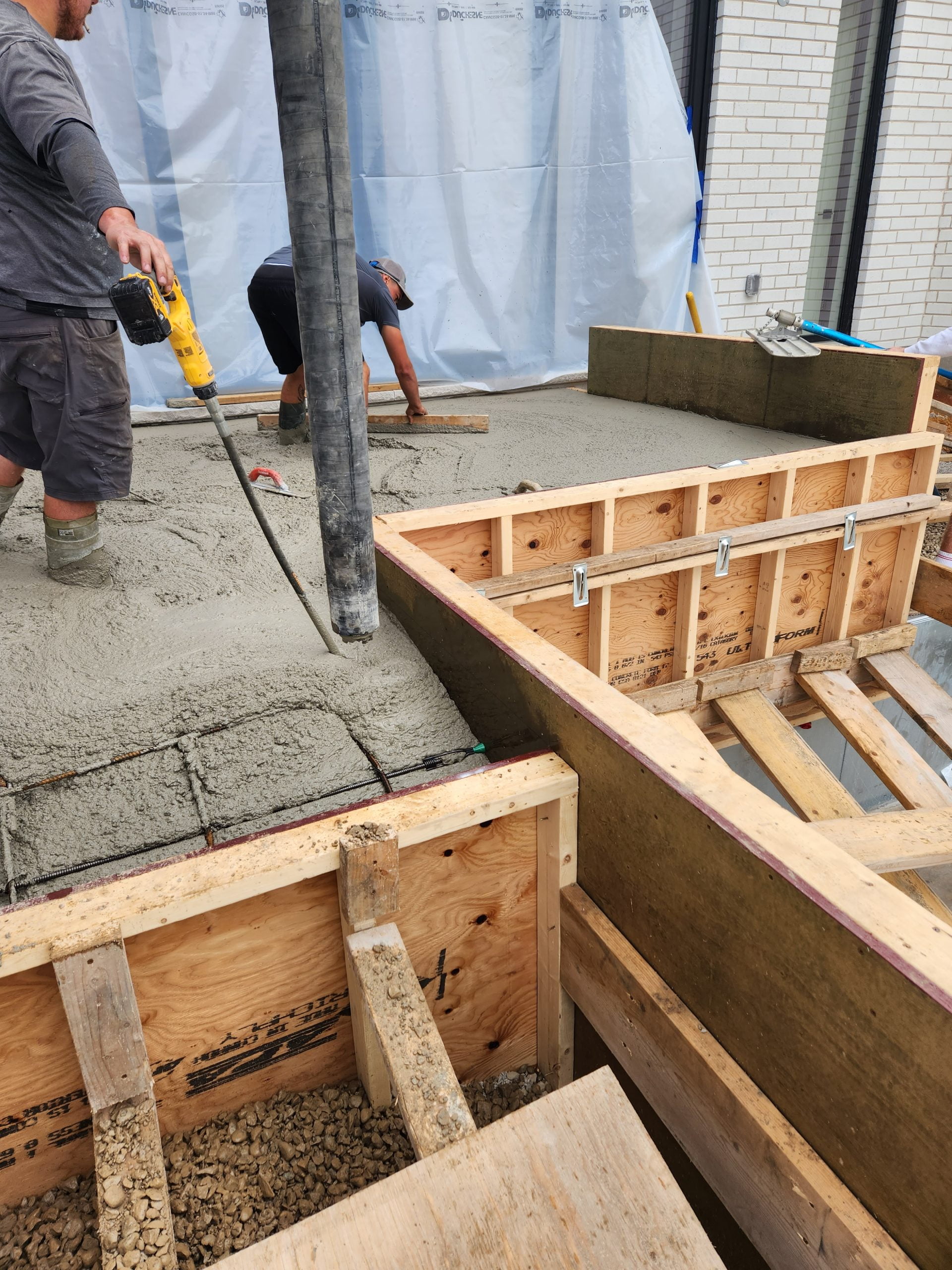 smoothing out fresh concrete for custom concrete patio
