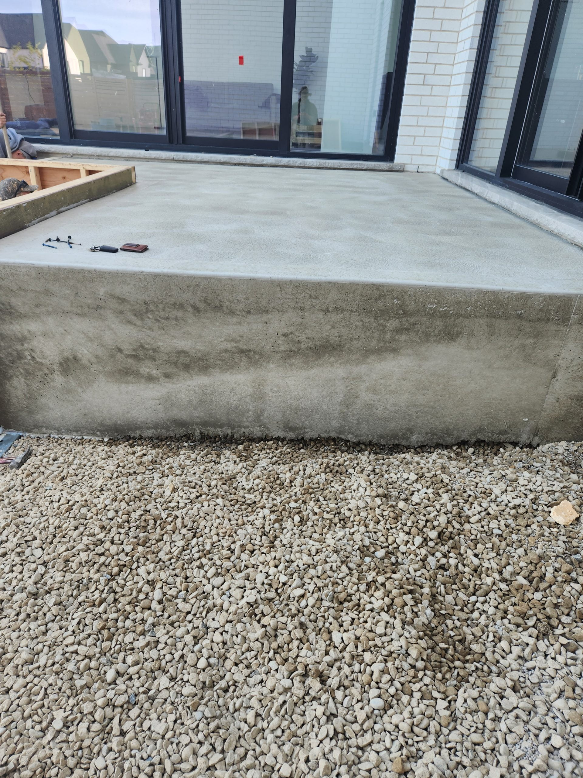 upper level of new multi-level raised concrete patio with a hand spun finish after forms removed