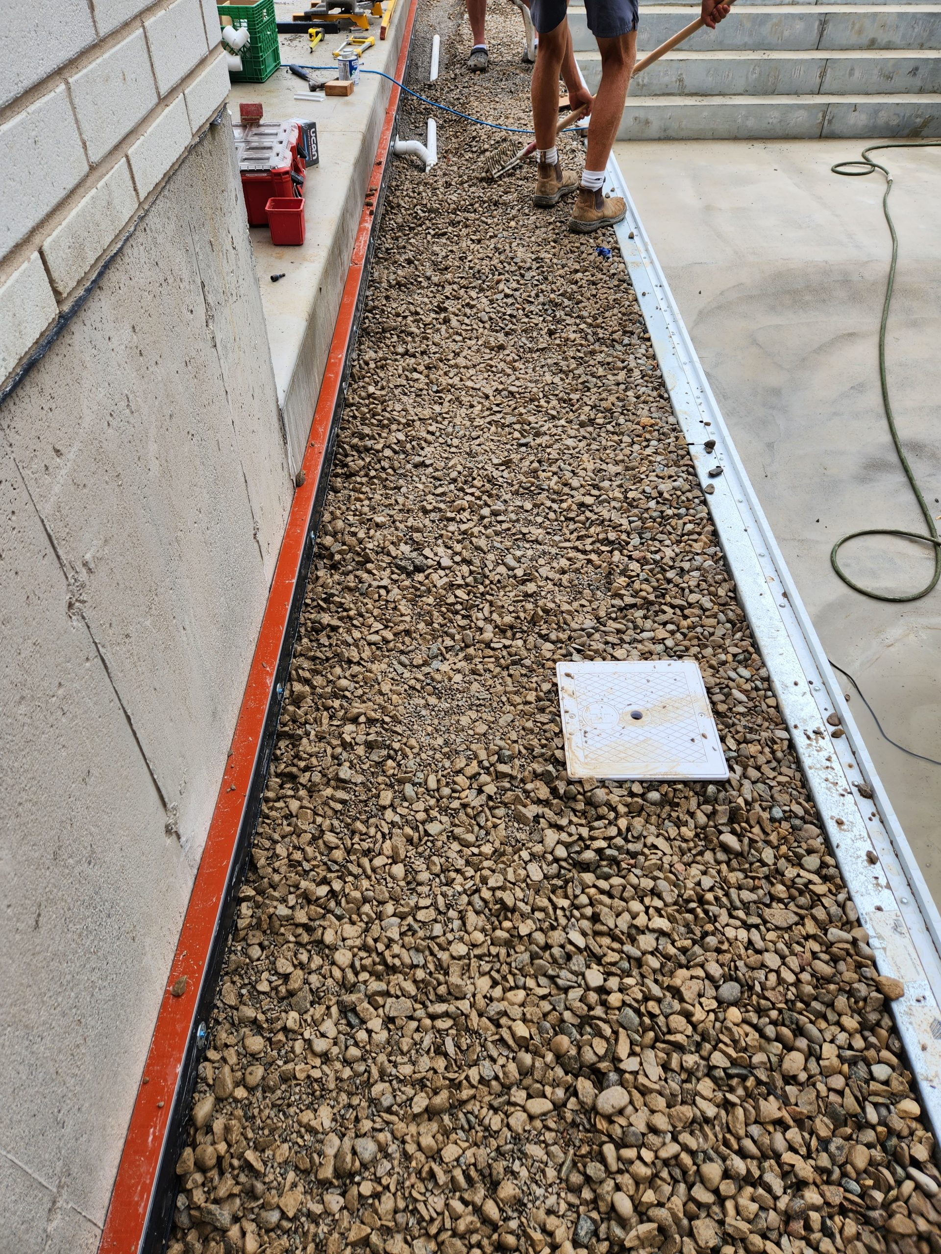 adding strip drain to move water away from house during pool and patio installation