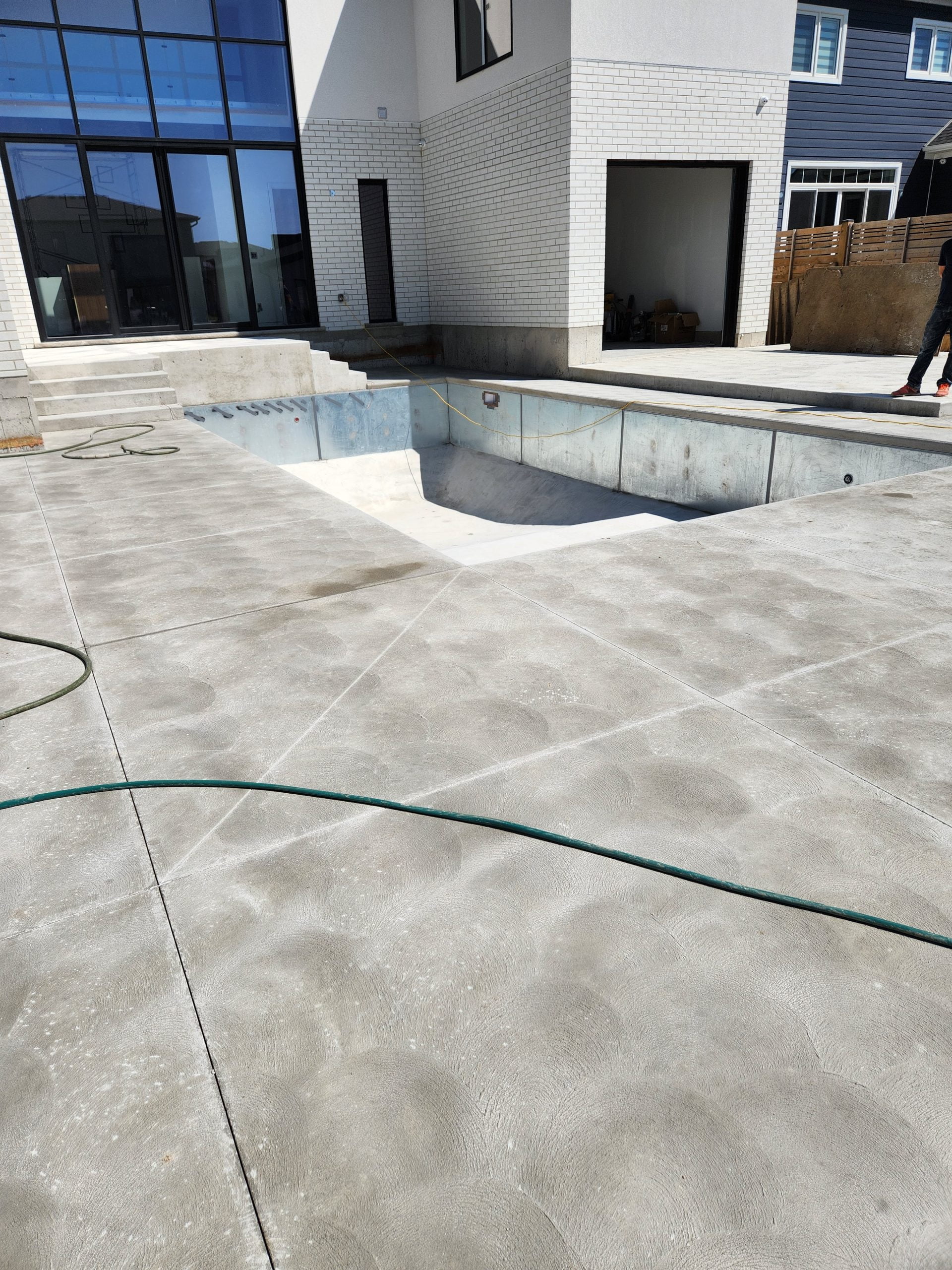 finished concrete phase of custom pool installation after relief cuts