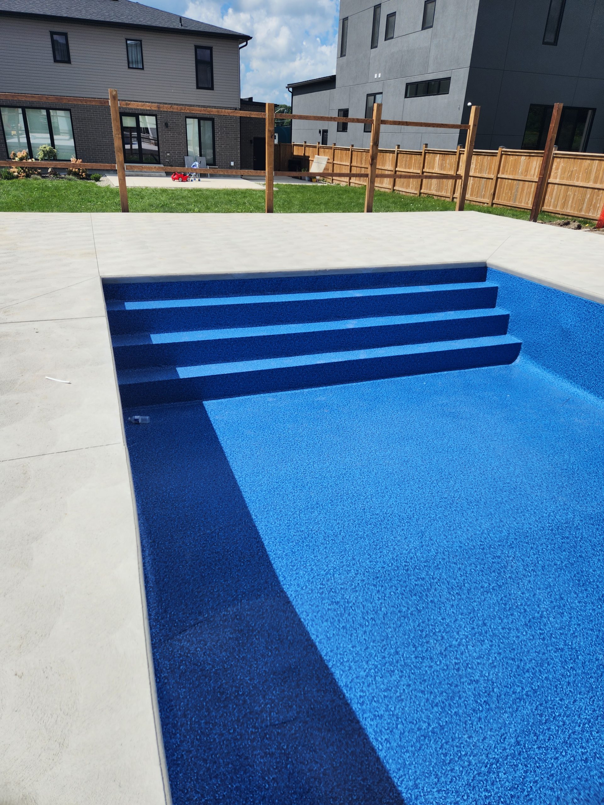 newly installed vinyl liner over concrete pool base and custom steel stairs